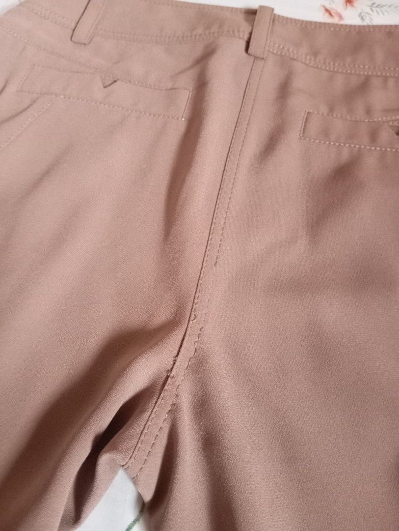 Brown high-waisted cropped trousers with cuffed hem (Category: Jeans) located in Cabanatuan. Submitted by w3ng.gay (Listing ID 1468763373, Image 3). Description: - Color: Versatile neutral brown - Fit: High-waisted with a stylish pleated front - Details: Double-button waistband, slanted pockets, and rolled cuffs - Back: Two welt pockets with button detail - Material: Smooth and lightweight fabric - Condition:loose stitching but can ne sewn bur st