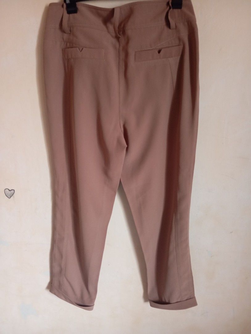 Brown high-waisted cropped trousers with cuffed hem (Category: Jeans) located in Cabanatuan. Submitted by w3ng.gay (Listing ID 1468763373, Image 2). Description: - Color: Versatile neutral brown - Fit: High-waisted with a stylish pleated front - Details: Double-button waistband, slanted pockets, and rolled cuffs - Back: Two welt pockets with button detail - Material: Smooth and lightweight fabric - Condition:loose stitching but can ne sewn bur st