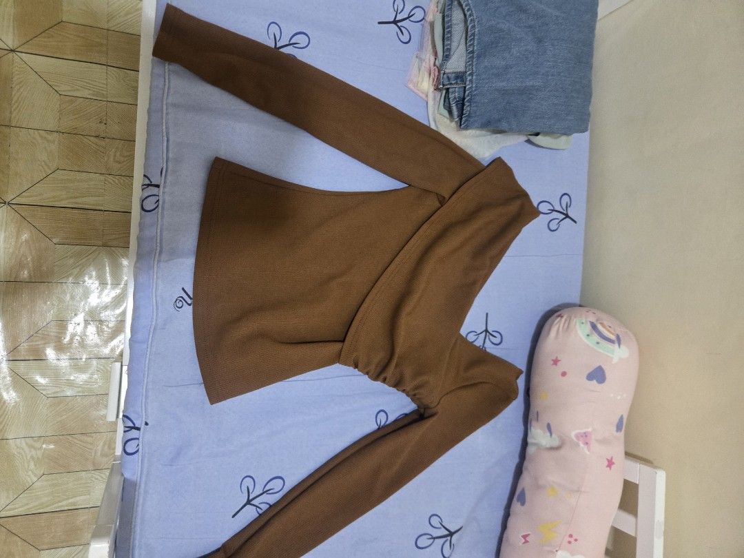 Brown Off-Shoulder Long Sleeve Ribbed Top (Category: Longsleeves) located in Binangonan. Submitted by jessapelic36849 (Listing ID 1468818282, Image 2). Description: - Color: Brown - Design: Off-shoulder neckline with wrap-style front and gathered side detailing - Fit: Slim fit silhouette - Fabric: Soft, stretchy ribbed material for all-day comfort - Styling: Versatile piece that easily matches with jeans or skirts for casual wear.