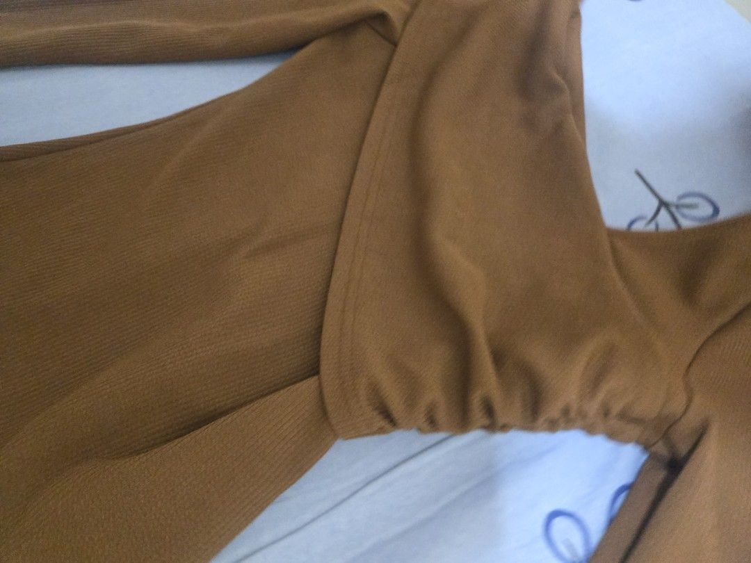Brown Off-Shoulder Long Sleeve Ribbed Top (Category: Longsleeves) located in Binangonan. Submitted by jessapelic36849 (Listing ID 1468818282, Image 3). Description: - Color: Brown - Design: Off-shoulder neckline with wrap-style front and gathered side detailing - Fit: Slim fit silhouette - Fabric: Soft, stretchy ribbed material for all-day comfort - Styling: Versatile piece that easily matches with jeans or skirts for casual wear.