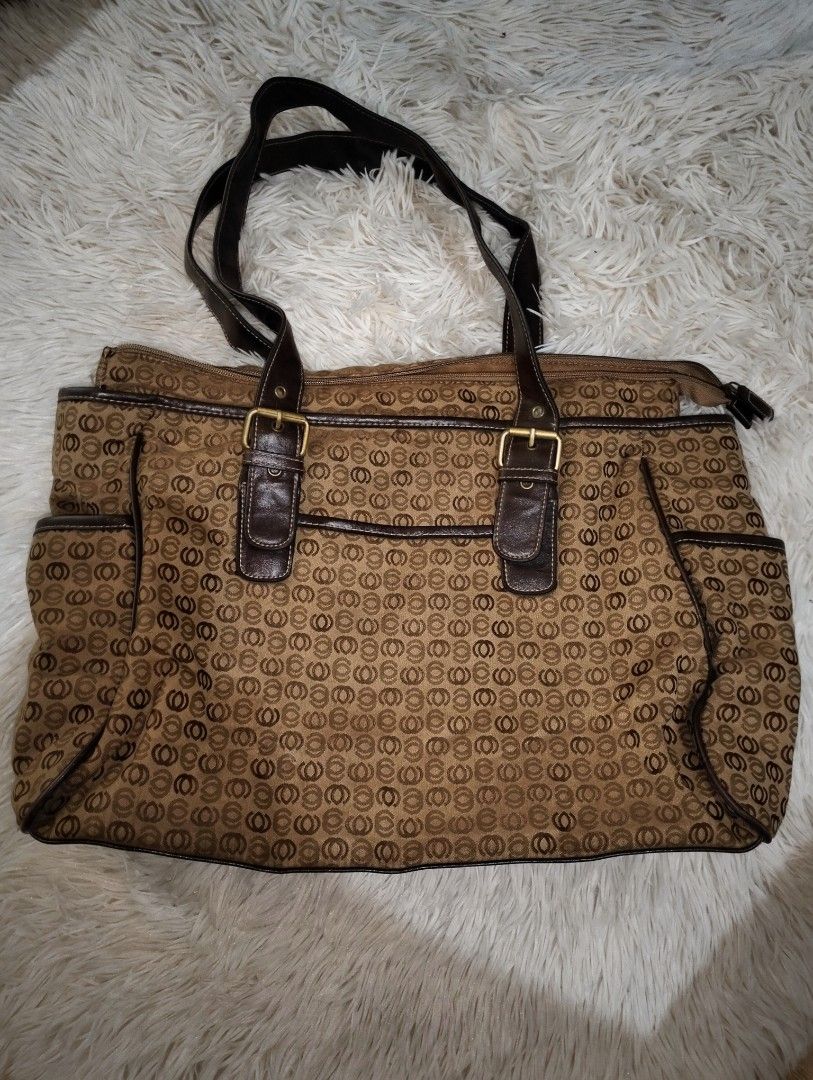 Brown Pattern Monogram Tote Bag with Buckle Details (Category: Tote Bags) located in Manila. Submitted by littlenicsfinds (Listing ID 1468738921, Image 2). Description: - Unisex sylish brown tote bag with all-over repeating pattern - Durable dark brown faux leather straps and trim - Elegant gold-tone buckle accents on the front - Secure top zipper closure - Convenient side slip pockets for quick-access items - Spacious interior ideal for everyday