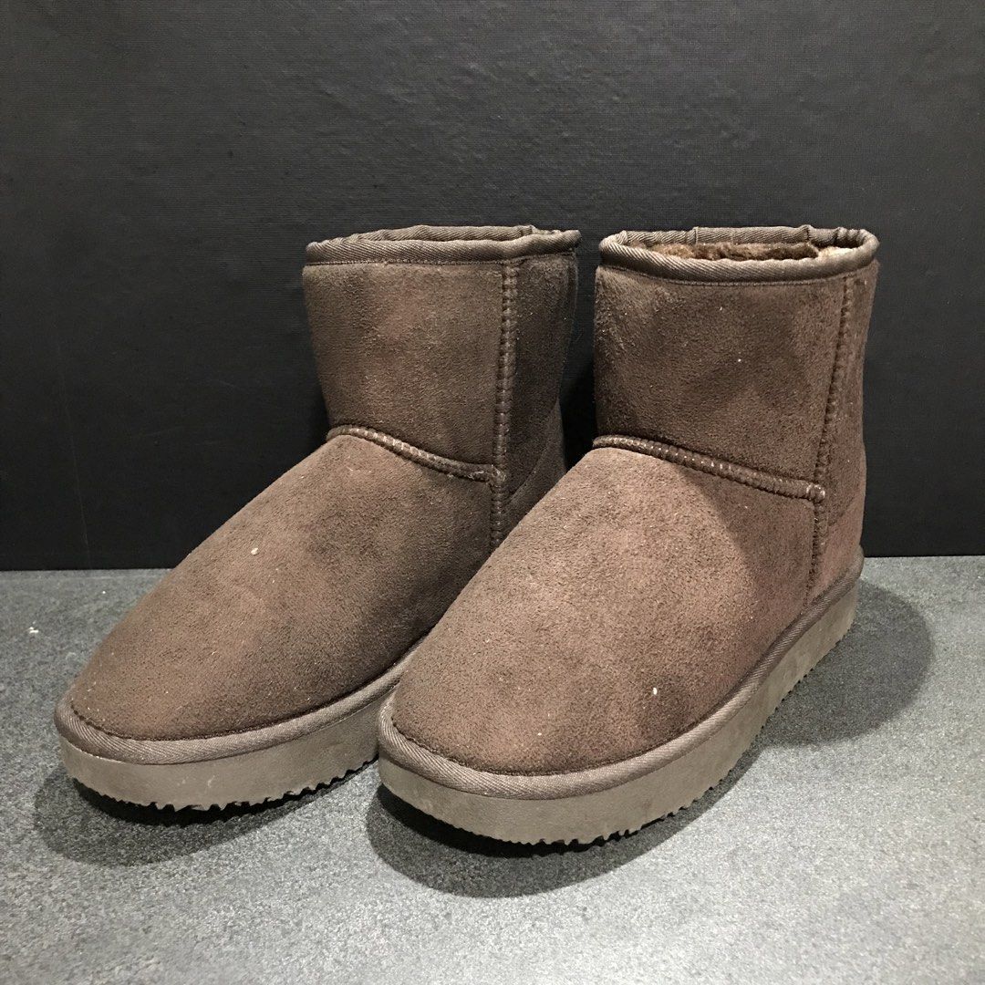 Brown suede winter boots with furry lining (Category: Boots) located in Baao. Submitted by all.things.japan (Listing ID 1468747461, Image 1). Description: - Size: 38 (indicated on sole sticker) - Material: Brown suede upper with thick plush lining - Style: Slip-on ankle boots, easy to pull on and off - Sole: Textured rubber for extra grip and safety - Condition: Great for chilly days and winter wear.