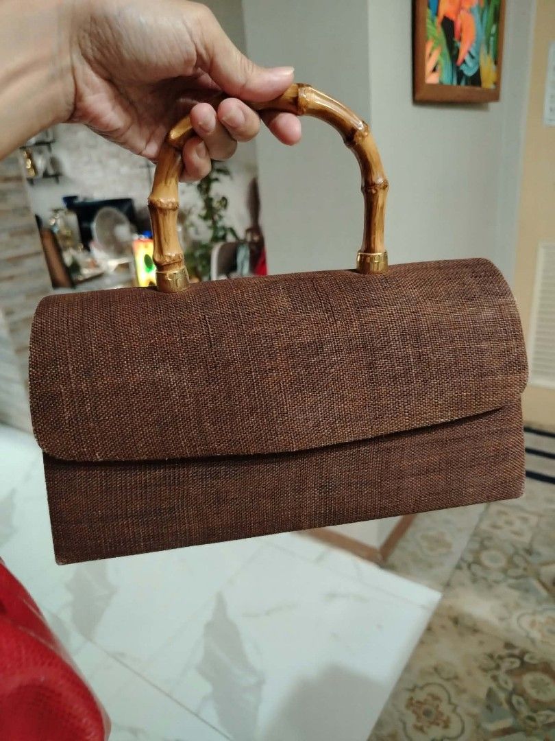 Brown woven handbag with bamboo handle (Category: Shoulder Bags) located in Paranaque City. Submitted by yensfashionfinds (Listing ID 1468740076, Image 3). Description: - Style: Textured brown handbag with a structured rectangular shape - Handle: Sturdy and stylish bamboo top handle - Hardware: Premium gold-tone accents throughout - Closure: Flap closure with a secure hidden magnetic snap - Interior: Light beige lining with a small side pocket an