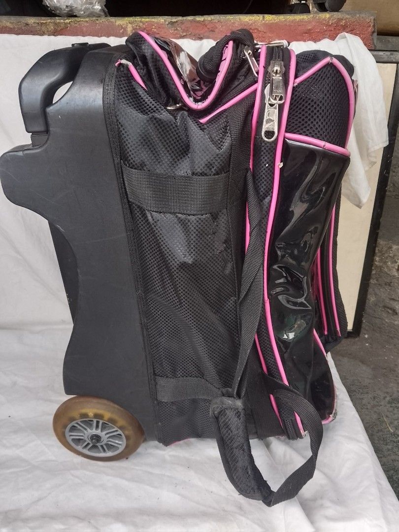 Brunswick Rolling Bowling Bag Black Pink (Category: Billiards and Bowling) located in Quezon City. Submitted by jpnvintageonline (Listing ID 1468832970, Image 3). Description: - Authentic Brunswick rolling bowling bag in stylish black and pink - Glossy front panel with repeated logo print - Equipped with an extendable handle, sturdy wheels, and carrying strap - Smooth-working zippers with plenty of storage space for gear and bowling shoes - Shows