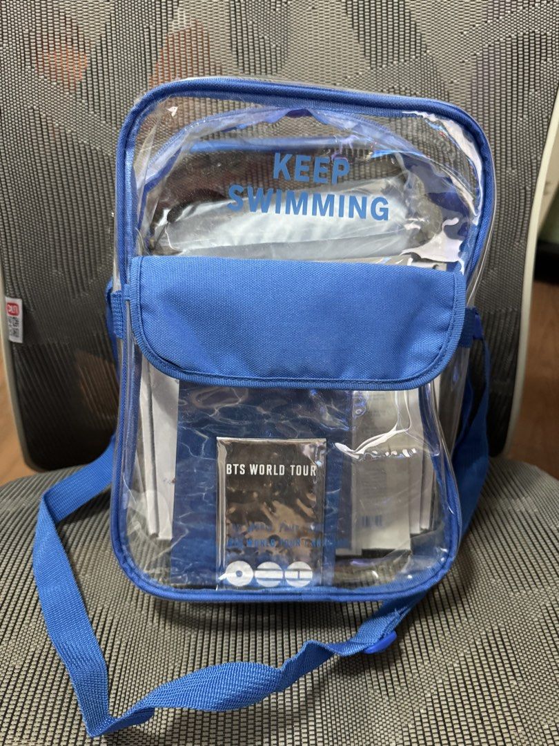 BTS World Busan Tour Gift Bag (Category: Cross-body Bags) located in Pasig City. Submitted by jubinnnie (Listing ID 1468801784, Image 1). Description: - Official BTS World Tour clear blue crossbody bag - Transparent durable body to easily see inner items - Adjustable blue shoulder strap for comfortable wear - Front flap pocket with unique water pattern design and BTS World Tour card insert - Stylish blue 'Keep Swimming' lettering near the top - S