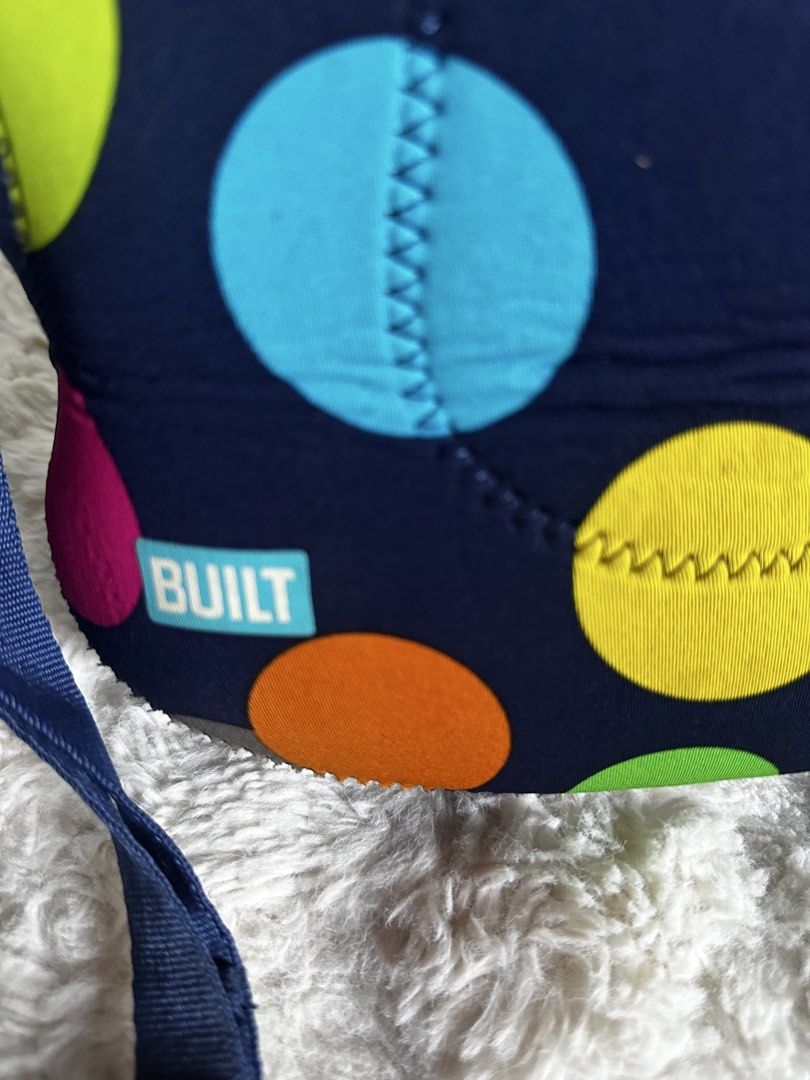 BUILT Neoprene Lunch Tote Bag Polka Dot (Category: Tote Bags) located in Digos. Submitted by venusacaro13427 (Listing ID 1468774215, Image 2). Description: - Brand: BUILT - Design: Navy blue with colorful polka dots and bright turquoise interior - Material: Stretchy, insulating neoprene - Features: Dual top handles, adjustable shoulder strap with white clips, and front brand tag - Condition: Light signs of previous use at the bottom - Perfect for