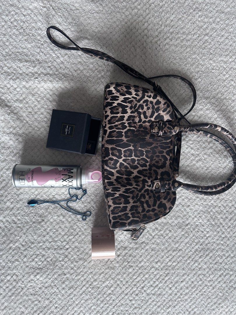 Bundle Leopard Print Handbag with Shoulder Strap (Category: Shoulder Bags) located in Manila. Submitted by aleks_365_pryz (Listing ID 1468741107, Image 1). Description: Bundle: Bershka bag Hair styling spray Tape Necklace - Style: Leopard print handbag with dark brown and tan spots - Material: Textured faux leather - Carry Options: Dual top handles and a long crossbody strap - Closure: Zip top closure for security - Capacity: Roomy enough for dai
