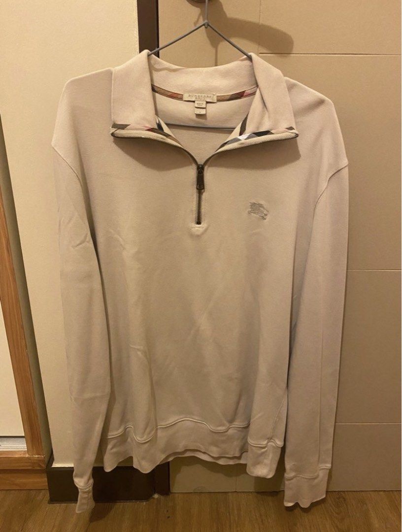 Burberry Brit Quarter Zip Sweater (Category: Tshirts & Polo Shirts ) located in Pasig City. Submitted by yopops (Listing ID 1468782503, Image 1). Description: - Brand: Burberry Brit - Style: Quarter zip - Color: Beige - Size: Medium (M); 28x21 - Details: Embroidered knight logo on chest, checkered inner collar lining, branded zipper pull - Material: Comfortable knit fabric, great for layering - Condition: Clean and well-maintained .