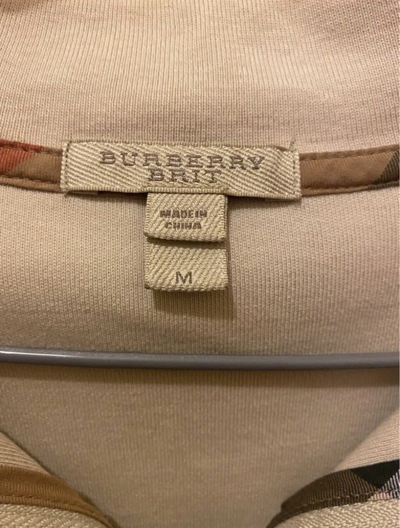 Burberry Brit Quarter Zip Sweater (Category: Tshirts & Polo Shirts ) located in Pasig City. Submitted by yopops (Listing ID 1468782503, Image 3). Description: - Brand: Burberry Brit - Style: Quarter zip - Color: Beige - Size: Medium (M); 28x21 - Details: Embroidered knight logo on chest, checkered inner collar lining, branded zipper pull - Material: Comfortable knit fabric, great for layering - Condition: Clean and well-maintained .