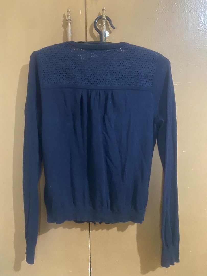 Burberry long sleeve button-up cardigan with patterned back (Category: Longsleeves) located in Muntinlupa City. Submitted by swiftowl.0cc8ab (Listing ID 1468855960, Image 2). Description: - Color: Dark blue - Design: Solid front with an intricate cutout pattern on the upper back/shoulders - Fit: Standard fit with long sleeves and front button closure - Material: Lightweight knit, great for layering over tops and dresses - Vintage piece, bought it