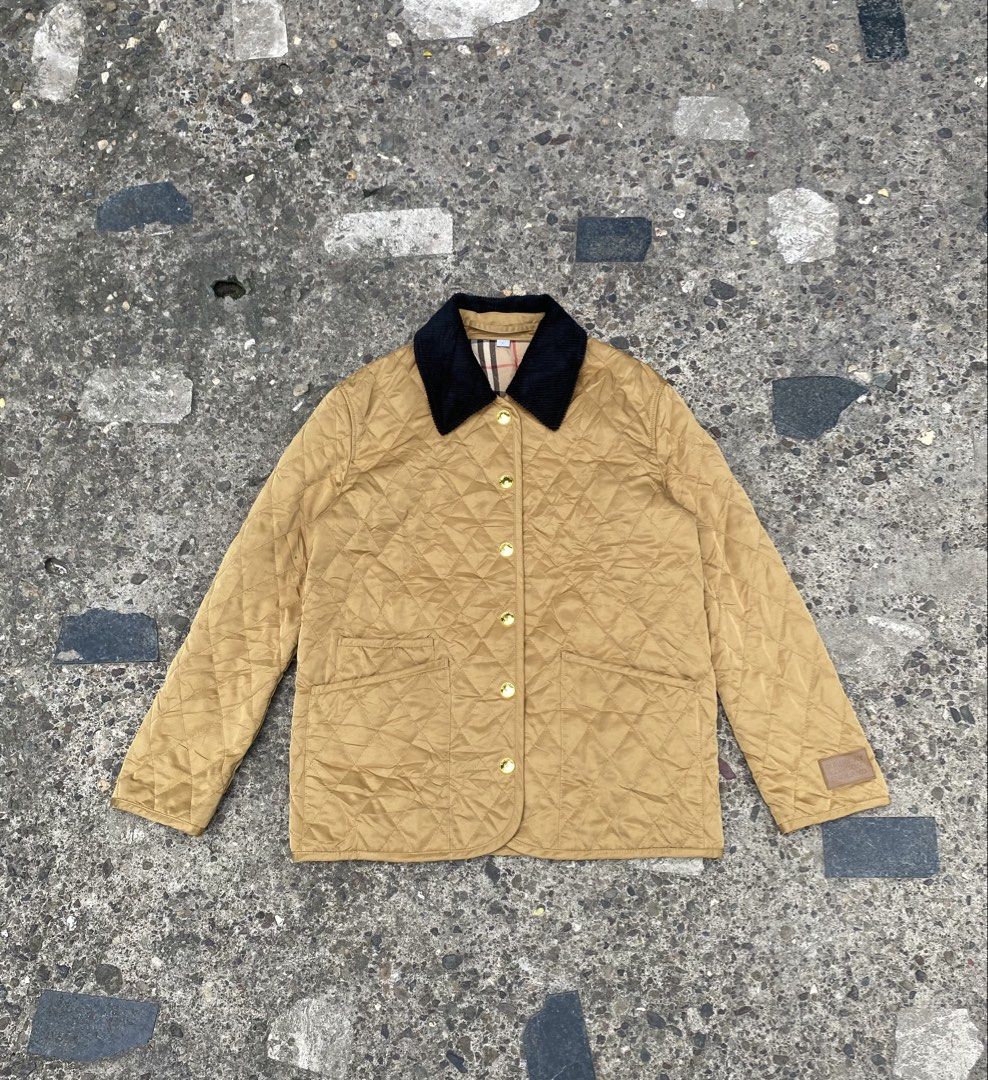 Burberry Quilted Dranefeld Barn Jacket (Category: Coats, Jackets and Outerwear) located in Caloocan City. Submitted by gaylawanna22819 (Listing ID 1468855664, Image 2). Description: - Brand: Burberry - Style: Quilted Dranefeld barn jacket - Color: Camel with black corduroy collar - Size: M (Tag at collar) - Details: Gold-tone snap button closure, two front patch pockets - Lining: Classic Burberry check - Branding: Burberry London England logo pat