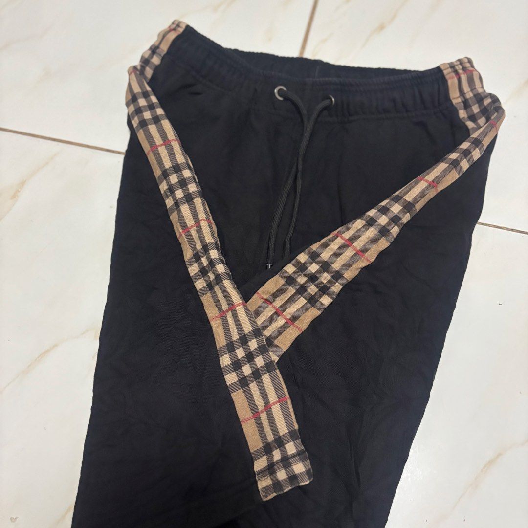 Burberry short (Category: Shorts) located in San Fernando. Submitted by diff.thr1ft (Listing ID 1468864179, Image 2). Description: - Brand: Burberry - Color: Classic black with signature check side stripes - Material: Comfortable, high-quality fabric - Features: Adjustable drawstring waist with branded metal aglets, inner brand tag - Condition: Excellent pre-loved condition - Style: Casual, trendy, and versatile shorts.