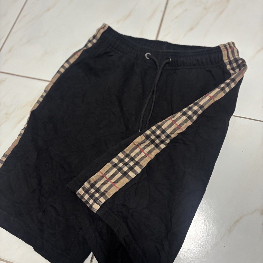 Burberry short (Category: Shorts) located in San Fernando. Submitted by diff.thr1ft (Listing ID 1468864179, Image 3). Description: - Brand: Burberry - Color: Classic black with signature check side stripes - Material: Comfortable, high-quality fabric - Features: Adjustable drawstring waist with branded metal aglets, inner brand tag - Condition: Excellent pre-loved condition - Style: Casual, trendy, and versatile shorts.