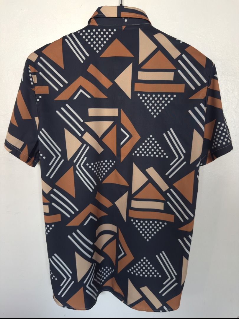Button Up Polo (Category: Tshirts & Polo Shirts ) located in Vigan. Submitted by potcholo. (Listing ID 1468865287, Image 2). Description: Geo Graphic Printed Button Up Polo Size: MEDIUM to SEMI LARGE 22 x 30 359 pesos only Very good condition.