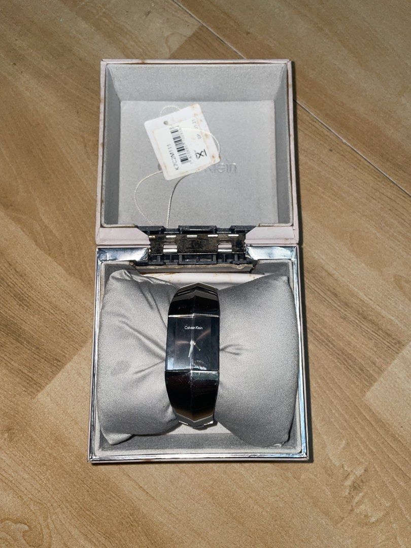 Calvin Klein Bangle Watch with Box (Category: Women's Watches) located in Davao. Submitted by newowl_777 (Listing ID 1468826273, Image 1). Description: - Brand/Model: Calvin Klein - Style: Sleek minimalist stainless steel bangle watch with a chic black face - Inclusions: Original branded presentation box and store tag included - Condition: Minor hairline scratches on the metal surface from handling, otherwise beautiful and fully functional - Perf