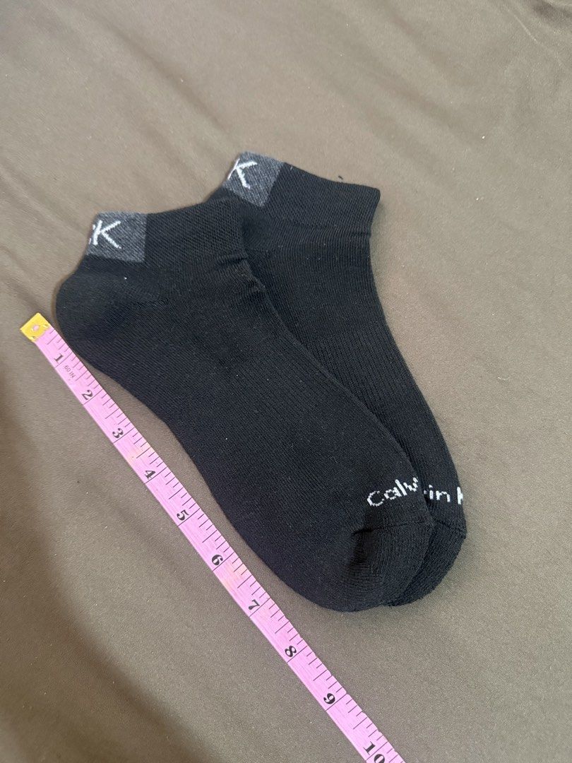 Calvin Klein Black Ankle Socks CK Logo (Category: Socks) located in Quezon City. Submitted by turtleandfishes (Listing ID 1468738377, Image 3). Description: - Authentic Calvin Klein ankle socks in classic black - Cotton blend material for all-day comfort and breathability - Low-cut design sits right at the ankle, ideal for sneakers - Stylish grey heel cuff with white CK logo knit at the top - Features full Calvin Klein text spelled out near the t