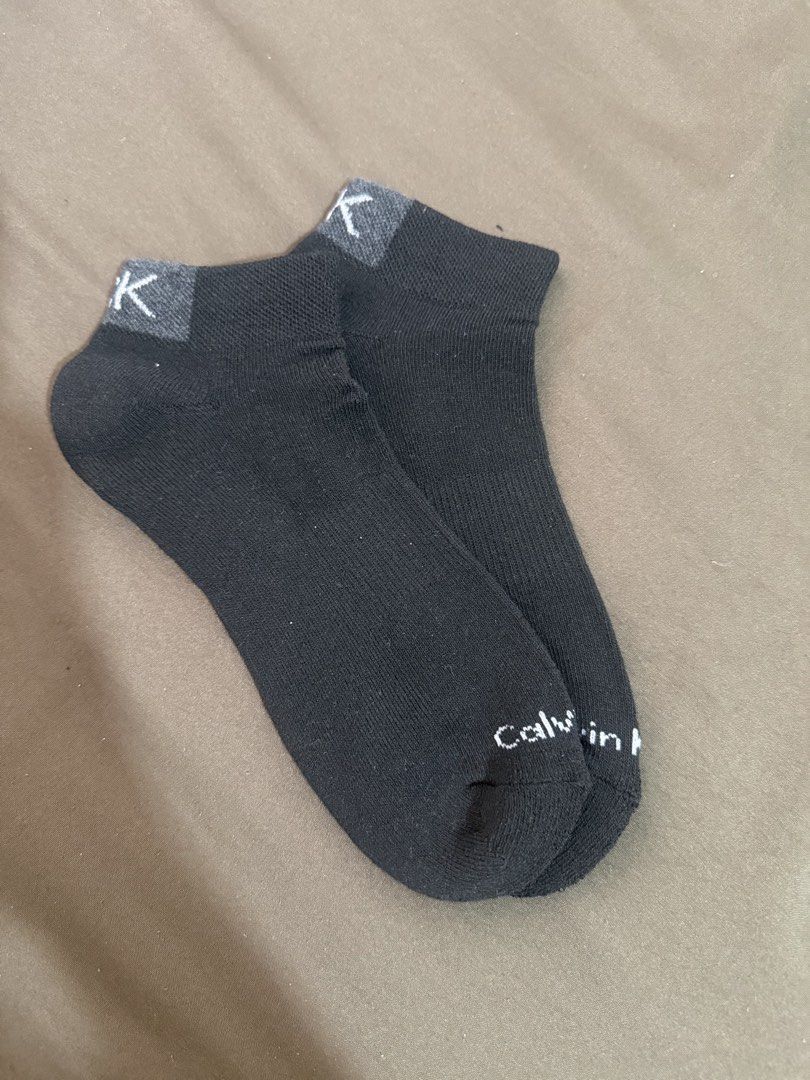 Calvin Klein Black Ankle Socks CK Logo (Category: Socks) located in Quezon City. Submitted by turtleandfishes (Listing ID 1468738377, Image 2). Description: - Authentic Calvin Klein ankle socks in classic black - Cotton blend material for all-day comfort and breathability - Low-cut design sits right at the ankle, ideal for sneakers - Stylish grey heel cuff with white CK logo knit at the top - Features full Calvin Klein text spelled out near the t
