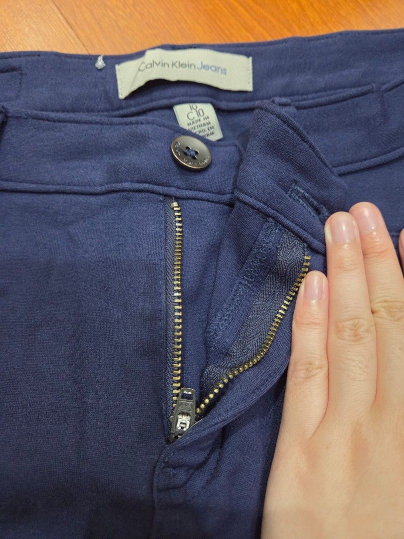 Calvin Klein Jeans Blue Pants Size 10 (Category: Jeans) located in Taguig. Submitted by mon_143 (Listing ID 1468909541, Image 2). Description: - Brand: Calvin Klein Jeans - Size: 10 (Tag inside) - Color: Dark Blue - Origin: Made in Vietnam - Material: Thick, textured fabric with stretch for comfort - Closure: Zip fly with button closure and belt loops - Pockets: Two back pockets featuring a signature stitched logo design - Condition: Excellent / 