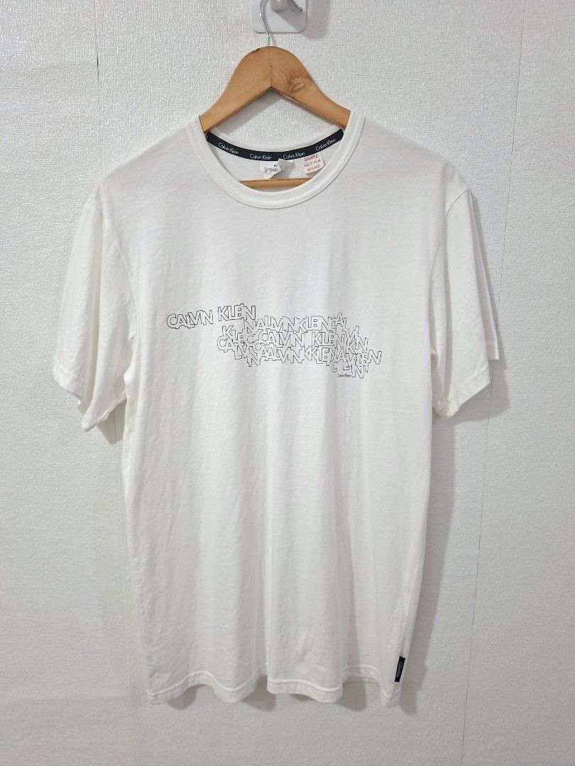 Calvin Klein multiple logo script (Category: Tshirts & Polo Shirts ) located in Cavite. Submitted by labbudds20 (Listing ID 1468926562, Image 2). Description: Calvin Klein multiple script logo design sample piece size medium armpit to armpit 20 inches length 30 inches like new condition see pictures for details.