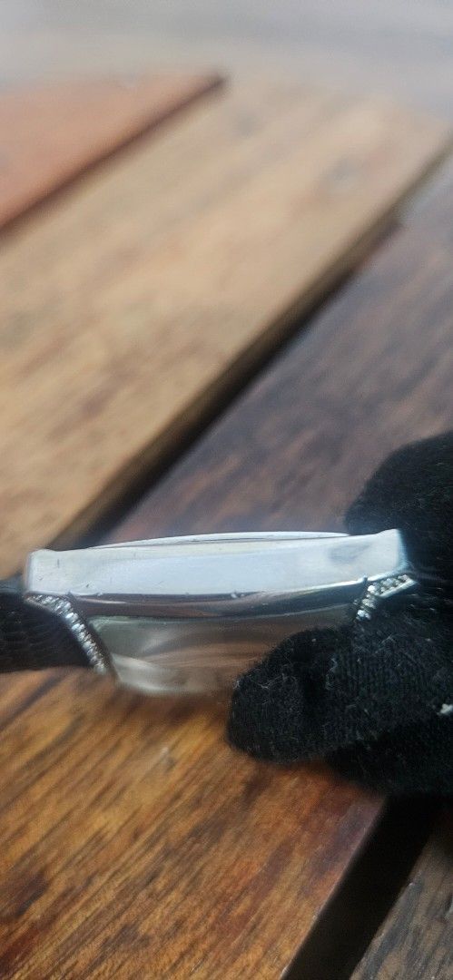 Caravelle by Bulova Watch (Category: Women's Watches) located in Santa Maria. Submitted by rommelmateo (Listing ID 1468861758, Image 3). Description: - Brand: Caravelle by Bulova - Dial: Silver with large numbers at 12, 3, 6, and 9 - Bezel: Rhinestone-encrusted top and bottom - Case: Curved rectangular stainless steel (standard light scuffs on the back from normal wear) - Strap: Textured black leather - Condition: Keeps time very well.