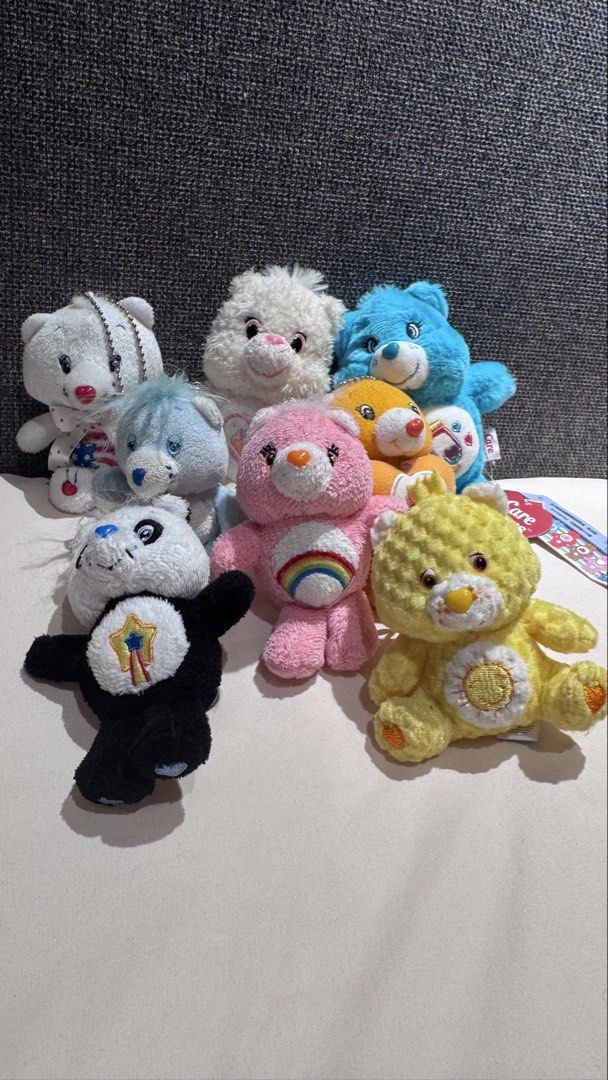 Care Bears plush keychain bundle lot of assorted bears (Category: Plushies & Soft Toys) located in Mandaluyong City. Submitted by maelovestoshop (Listing ID 1468873705, Image 1). Description: Bundle of assorted Care Bears plush toys and keychains. Features characters in different colors including pink with rainbow belly badge, yellow with sun emblem, blue with music notes, white, and a panda bear plush. Various sizes and styles with ball chains a