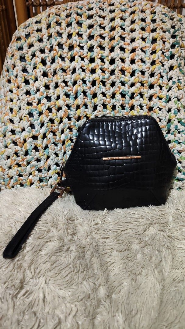 Carlyn Black Croc Embossed Wristlet Handbag (Category: Purses & Pouches) located in Cebu City. Submitted by lumaynojes00490 (Listing ID 1468800481, Image 2). Description: - Color: Classic Black with sophisticated rose gold hardware - Texture: Stylish all-over croc-embossed design - Shape: Trendy and structured hexagonal silhouette - Closure: Secure top-zip closure - Convenience: Comes with an attached wrist strap for easy carrying - Capacity: Com