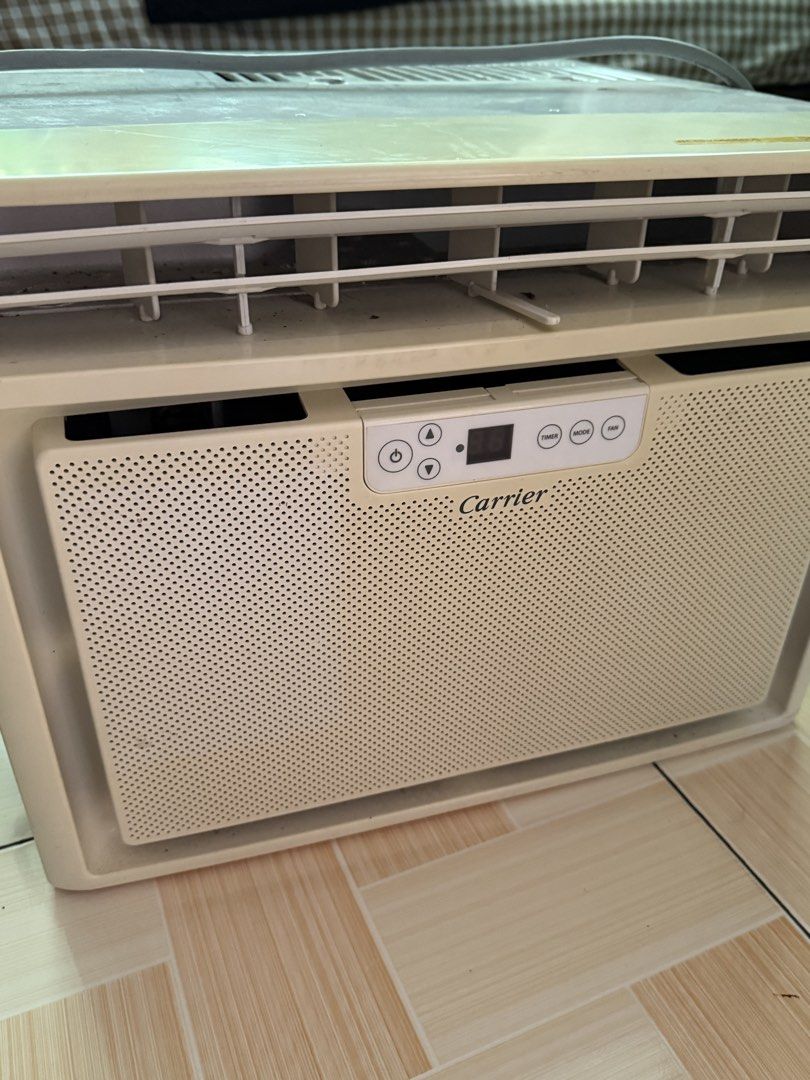 Carrier Window Type Air Conditioner (Category: Air Conditioning and Heating) located in Quezon City. Submitted by llito29 (Listing ID 1468776879, Image 2). Description: - L: 18.5 in W: 20.5 in H: 14 in - Brand/Model: Carrier Window Type AC (WCARK006EECG) - Power: 230V, 60Hz - Cooling Capacity: 1.67 kW - Features: Digital control panel, timer, multiple mode and fan buttons - Cosmetic Condition: White casing with some dirt marks on top and slight y