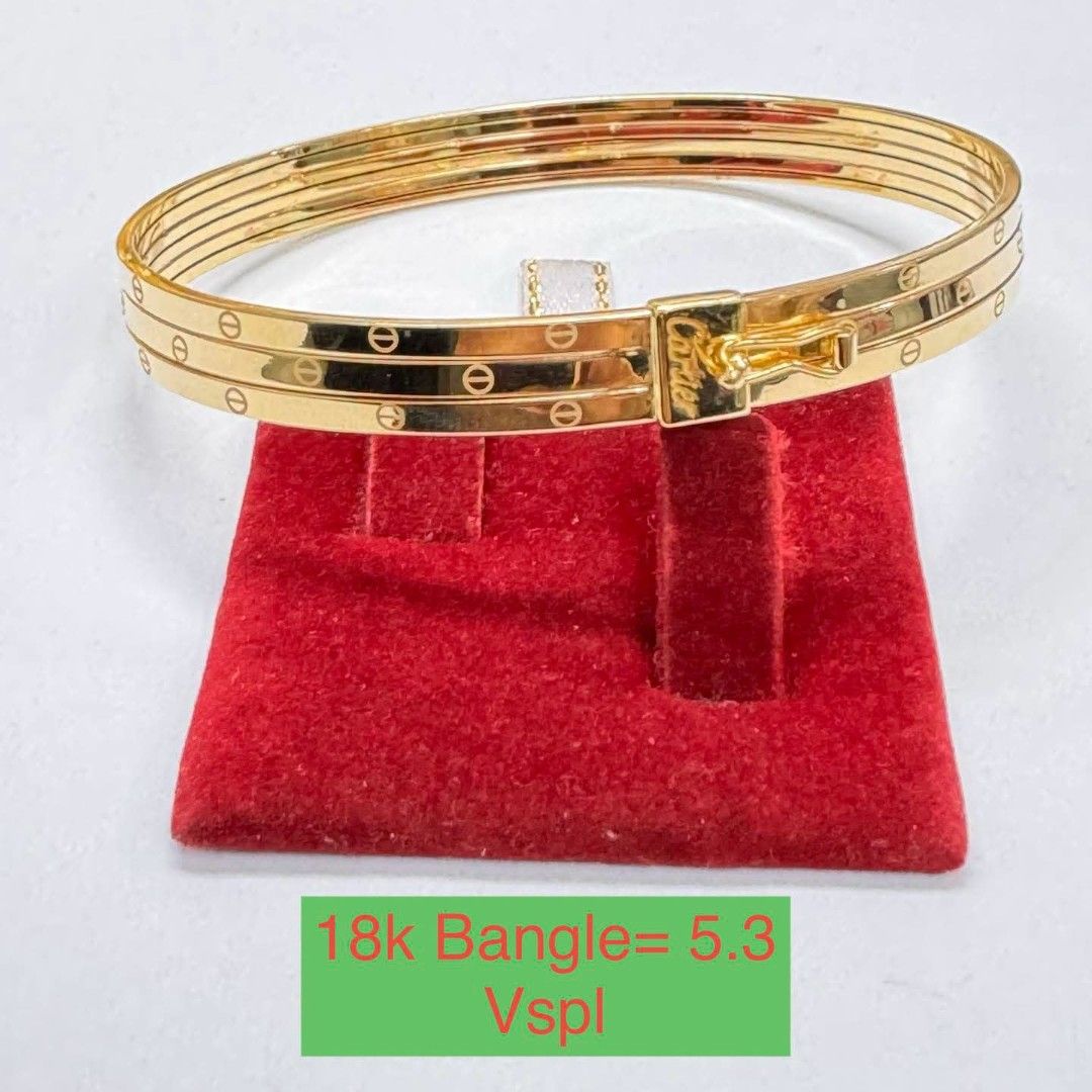 Cartier 18k Gold Bangle Bracelet (Category: Bracelets) located in Marikina City. Submitted by emmstaule (Listing ID 1468714128, Image 1). Description: - Authentic Cartier bangle in 18k yellow gold - Multi-band design featuring classic screw motif engravings - Secure clasp closure with engraved Cartier logo - Approximate weight: 5.3 grams - Comfortable fit with a timeless, elegant look - Includes a red display pad for safekeeping.