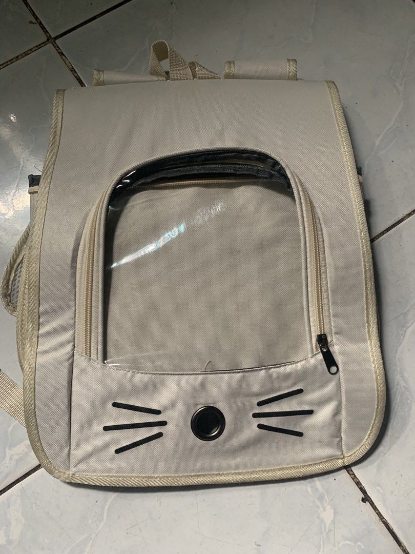 Cat Carrier Backpack (Category: Backpacks) located in Valenzuela. Submitted by diane.35 (Listing ID 1468749437, Image 2). Description: - Brand new & sealed in plastic packaging - Color: Beige with cute cat whiskers and nose print - Features a clear bubble window and breathable mesh panels - Dimensions: 35cm x 25cm x 35cm - Ideal for cats and small dogs - Comfortable with adjustable padded shoulder straps and sturdy top handle.