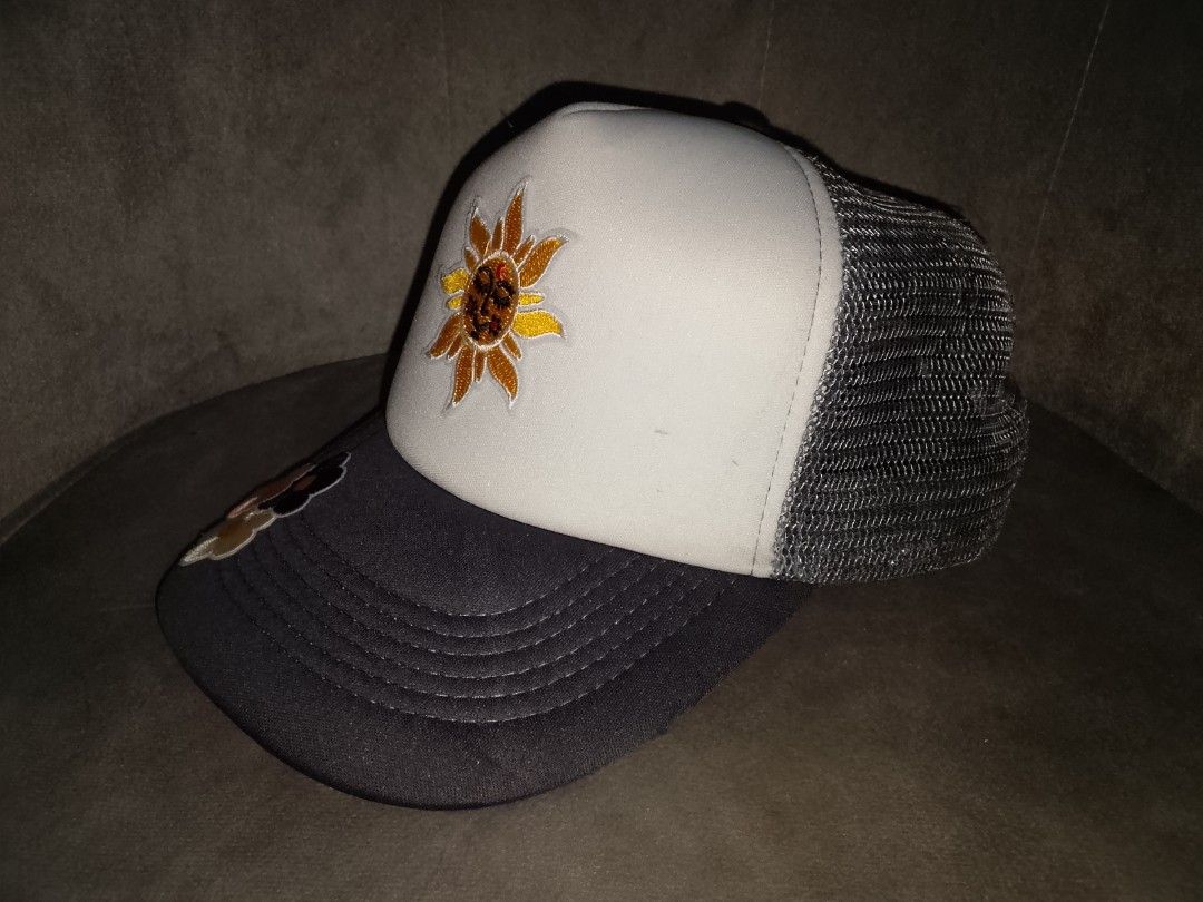 Celestial Sun & Floral Embroidered Trucker Hat (Grey/White) (Category: Hats & Beanies) located in Binangonan. Submitted by yuristalin888 (Listing ID 1468720595, Image 2). Description: Add a touch of whimsical charm to your everyday look with this stylish trucker hat. Featuring a peaceful embroidered smiling sun face on the white front panel and a trio of colorful floral patches accenting the grey curved brim, this cap blends retro style with a pl