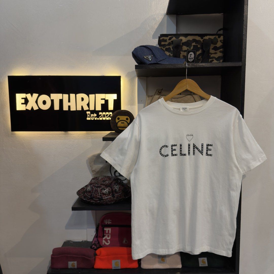 Celine by Hedi Slimane Studded White Shirt (Category: Tshirts & Polo Shirts ) located in Manila. Submitted by jerichomal82553 (Listing ID 1468899713, Image 1). Description: Celine by Hedi Slimane Studded White Shirt 21 by 27 Good Condition Complete Tags CLAIM 1300.