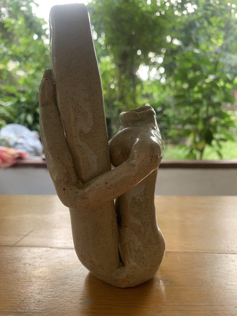 Ceramic Abstract Human Figure Hugging Pillar Vase (Category: Vases & Decorative Bowls) located in Quezon City. Submitted by sojisup (Listing ID 1468714881, Image 2). Description: - Unique handmade ceramic vase shaped like human figures hugging a central pillar - Beautiful speckled beige glaze with a glossy finish - Heavy clay build that sits flat and stable on wooden surfaces - Perfect for holding small stems or displaying as a standalone art pie