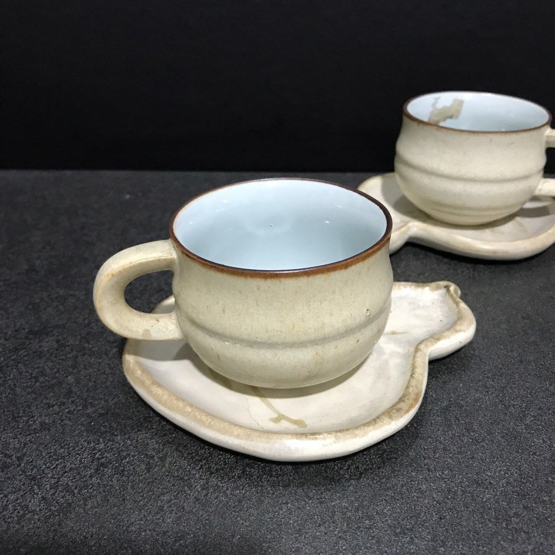 Ceramic Teacup and Gourd Shaped Saucer Set (Category: Coffee & Tea Tableware) located in Baao. Submitted by all.things.japan (Listing ID 1468747994, Image 3). Description: - Set includes: 2 ceramic teacups and matching gourd-shaped saucers - Design: Beige textured exterior with a glossy white interior and stylish brown rims - Aesthetic: Unique handmade style, perfect for everyday use or aesthetic table settings - Ideal for: Afternoon tea, coffee,