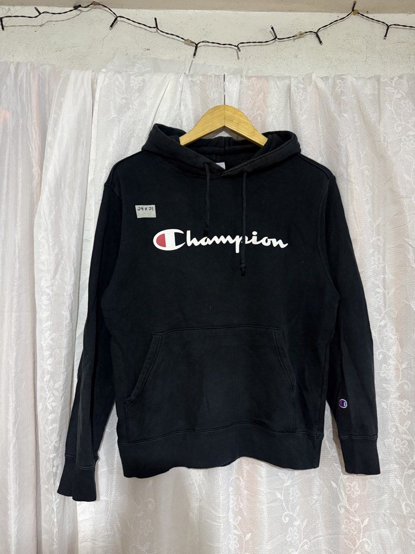 Champion Black Script Logo Hoodie (Category: Hoodies) located in Quezon City. Submitted by dapanaaaay (Listing ID 1468752331, Image 1). Description: - Color: Classic Black - Design: Iconic Champion script logo on chest with embroidered 'C' patch on left sleeve - Features: Adjustable drawstring hood and front kangaroo pocket - Fit/Size: Measures approximately 24" x 31" - Condition: Pre-loved with slight signs of wear, still in solid condition over