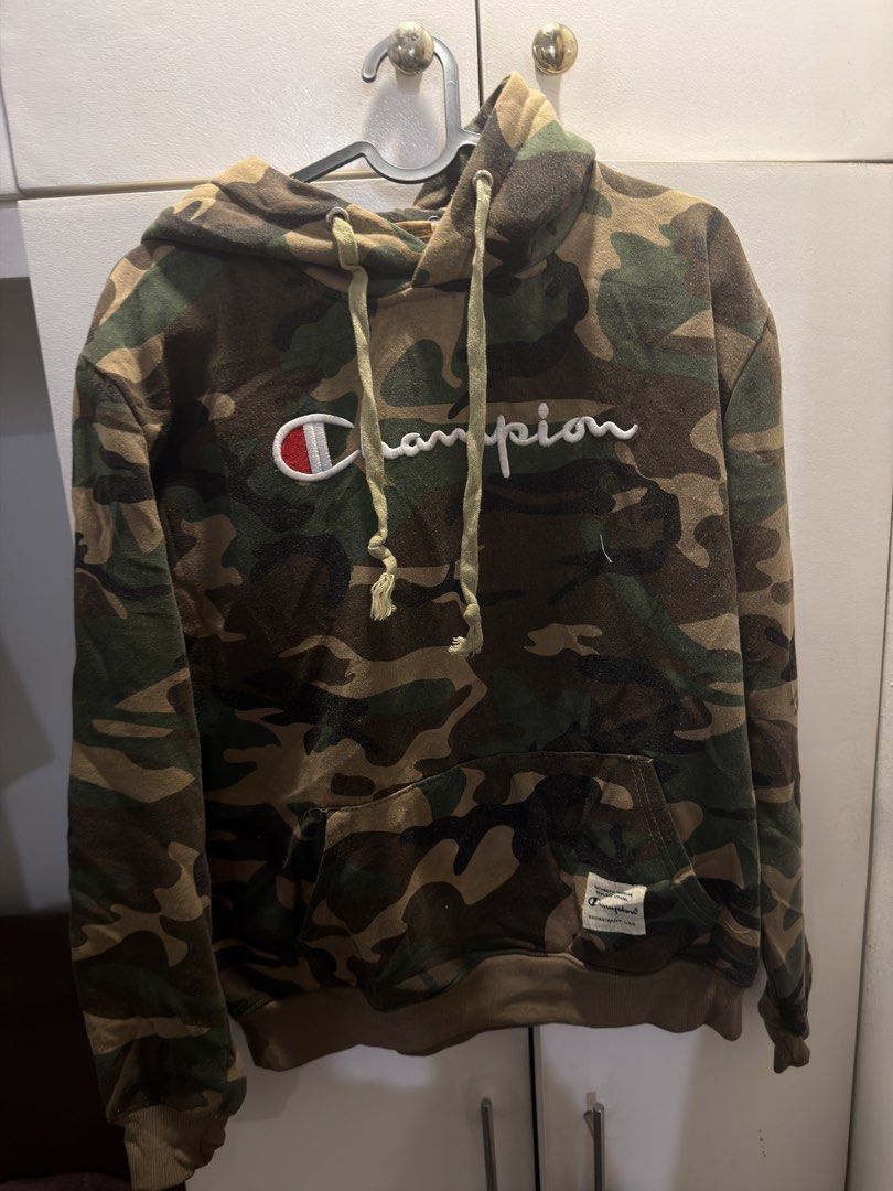 Champion Camo Script Hoodie (Category: Coats, Jackets and Outerwear) located in Manila. Submitted by johnlee0212 (Listing ID 1468877633, Image 1). Description: Champion Camouflage Script Logo Size on tag: Medium Dimes: W: 21 x L: 26 No issue Location: Cubao.