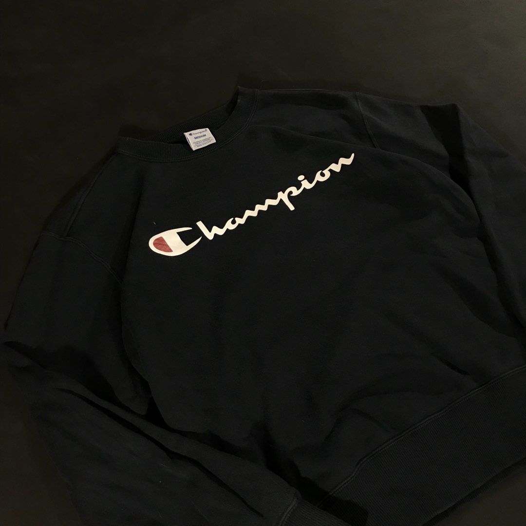 Champion Script Logo Crewneck Sweatshirt (Category: Coats, Jackets and Outerwear) located in Manila. Submitted by a_aron.f6e3a7 (Listing ID 1468786614, Image 1). Description: Size: Medium (M) Color rate: 9/10 (Navy Blue/Black with White & Red Script Logo) Condition: Excellent Issues: Visible wrinkles and creases from storage; no visible major holes or tears .