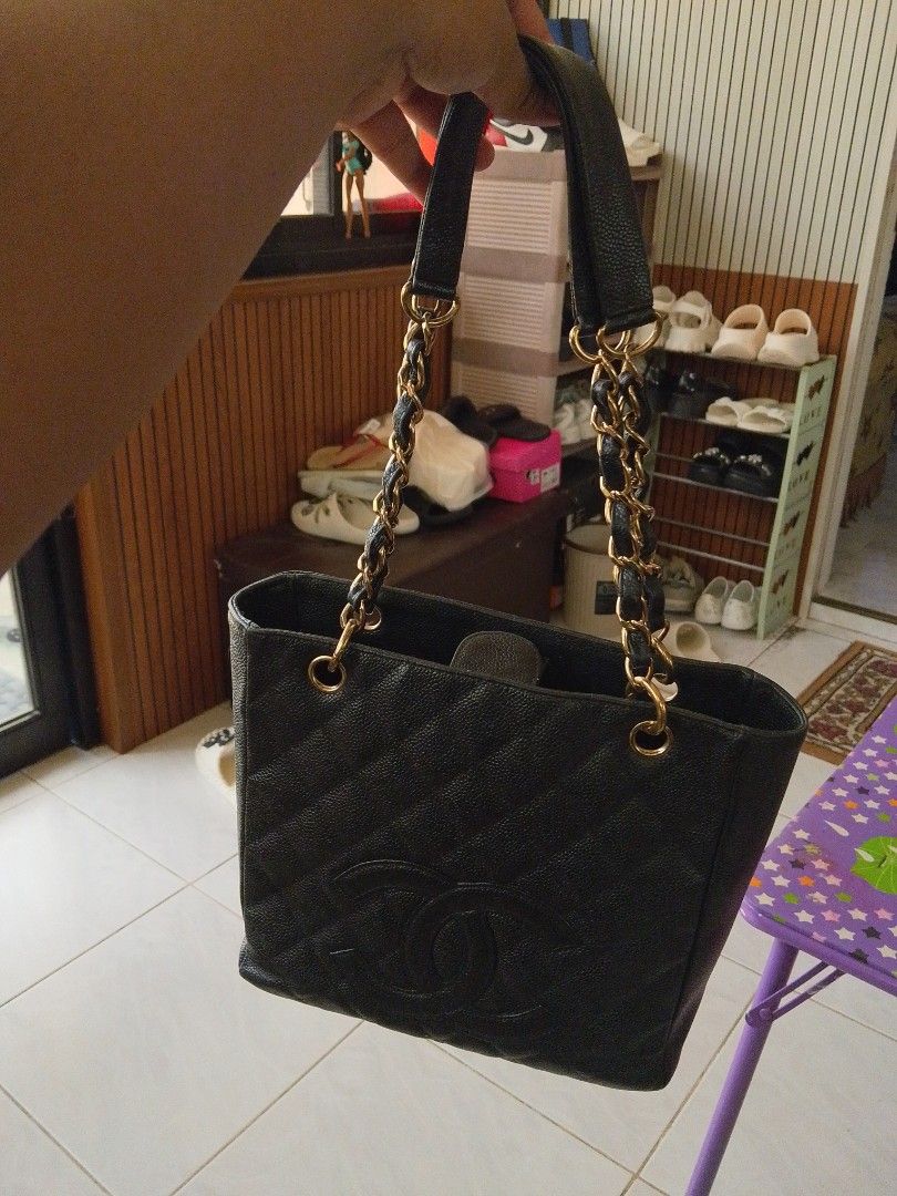 Chanel Black Caviar Leather Tote Bag (Category: Luxury Bags & Wallets) located in Koronadal. Submitted by thrifturight (Listing ID 1468721922, Image 1). Description: Black quilted leather tote bag from Chanel. Caviar leather finish with interlocking CC logo on the front. Gold-tone hardware mixed with leather woven through the chain straps. Open top design with compartments inside. Made in Italy leather tag sewn inside the lining. Structured shape