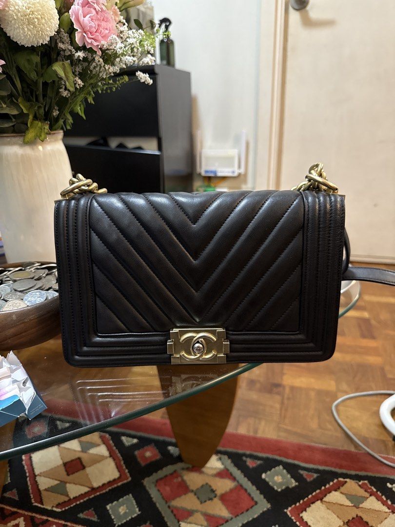 Chanel Boy Bag Black Chevron Leather (Category: Luxury Bags & Wallets) located in Taguig. Submitted by needtodeclutter___ (Listing ID 1468902556, Image 1). Description: - Brand: Chanel Boy Bag - Color / Material: Black leather with chevron quilting - Hardware: Aged gold tone with iconic CC lock closure - Origin: Made in Italy - Interior: Fabric lining with interior logo tag - Strap: Chain strap with leather shoulder guard - Condition: Classic str