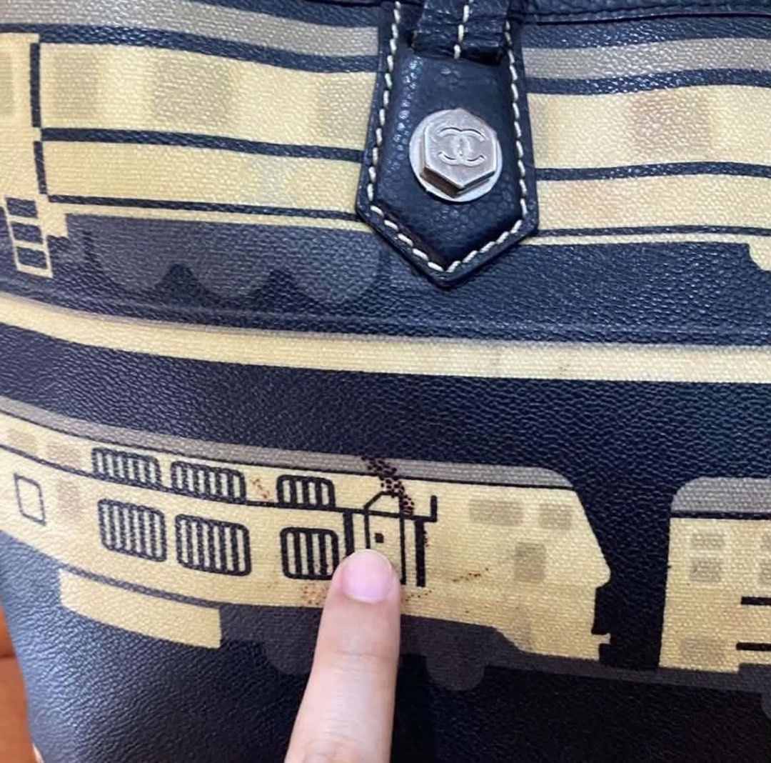 Chanel Train Print Canvas Tote Bag (Category: Tote Bags) located in Quezon City. Submitted by heybailey (Listing ID 1468817835, Image 3). Description: - Brand: Chanel - Color: Navy blue with train illustration and bold lettering - Hardware: Silver-tone CC hardware on strap attachments - Straps: Double leather straps with contrast stitching - Interior: Spacious and ideal for daily essentials - Condition: Minor discoloration/spots near the train gr