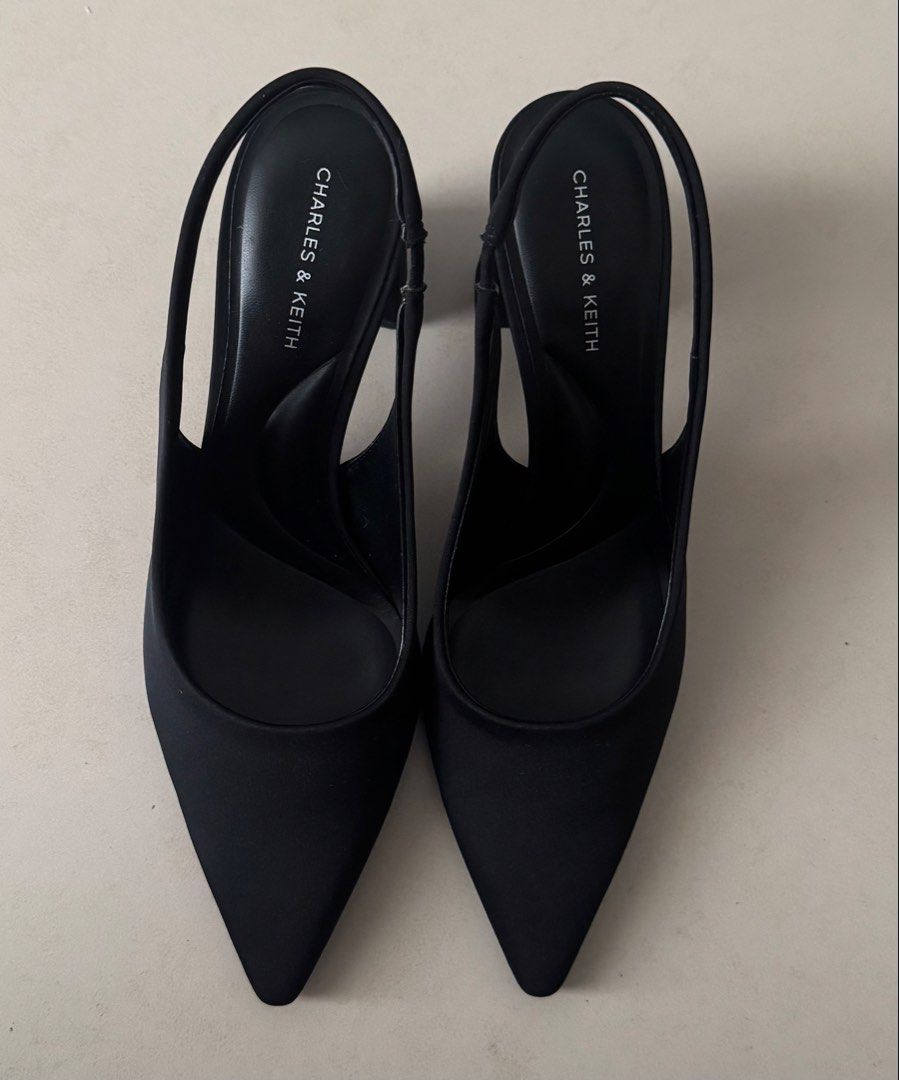 Charles & Keith Black Slingback Heels Size 37 (Category: Heels) located in Pasig City. Submitted by preloved0820 (Listing ID 1468755898, Image 2). Description: - Brand: Charles & Keith - Style: Slingback heels with pointed toe and chunky block heel - Size: 37 - Color: Classic black - Condition: Worn twice, with stickers still on soles so still like new - Features: Comfortable slip-on design with elastic back strap for secure fit Got this for almo