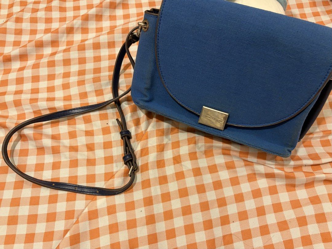 Charles & Keith Blue Denim Crossbody Bag (Category: Cross-body Bags) located in Manila. Submitted by jdace (Listing ID 1468847043, Image 1). Description: - Authentic Charles & Keith shoulder bag in trendy blue denim - Features a secure flap closure with a stylish metal clasp - Contrast dark blue trim and convenient adjustable strap - Normal wear visible around edges and corners from regular use - Price is negotiable for serious buyers, PM for inq