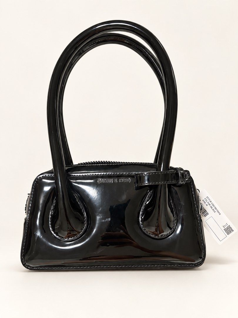 Charles & Keith Lula Patent Double Handle Bag - Black (Category: Luxury Bags & Wallets) located in Makati City. Submitted by rashmi911 (Listing ID 1468851242, Image 1). Description: - Brand: Charles & Keith - Model: Lula Patent Double Handle Bag - Color: Black with a glossy finish - Condition: Brand new, never used, original tag still attached - Features: Structured shape, curved handles - Size: Great for daily essentials or going out - Rushed cl