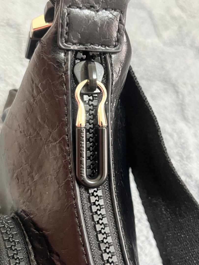 Charles & Keith Soleil Crinkle-Effect Shoulder Bag - Noir (Category: Shoulder Bags) located in Mandaluyong City. Submitted by leypadilla (Listing ID 1468733911, Image 3). Description: - Brand/Model: Charles & Keith Soleil shoulder bag - Color: Noir black with stylish crinkle-effect finish - Hardware: Sleek silver-tone accents - Storage: Convenient front zip pocket and secure main zipper closure - Details: Adjustable strap with buckle and side pul