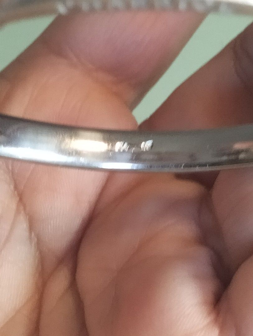 Charriol silver-tone bangle bracelet with engraved logo (Category: Bracelets) located in General Mariano Alvarez. Submitted by ma.miafajardo1219 (Listing ID 1468925544, Image 2). Description: - Brand: Charriol - Color/Finish: Silver-tone metal - Design: Curved metal plate with engraved brand name, smooth rounded band, and accent bolts - Authenticity: Stamped hallmark engraving on the inner surface - Style: Minimalist, versatile, and elegant - Con