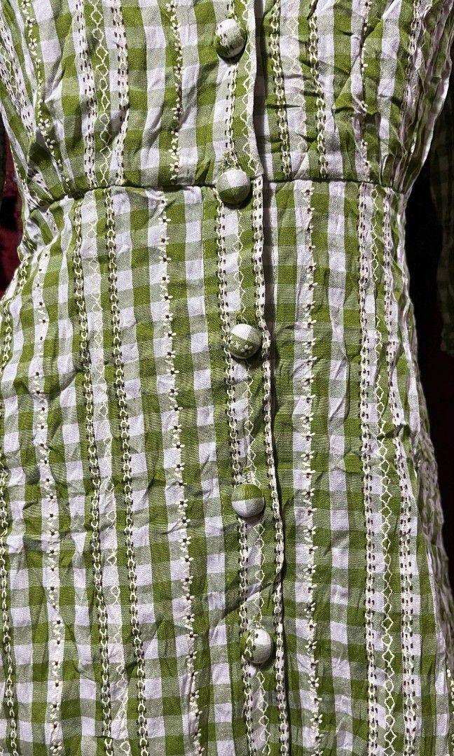 Chekered green mini dress (Category: Dresses) located in Manila. Submitted by wheneity67thifted (Listing ID 1468928071, Image 3). Description: This is a light green and white gingham check button-down dress featuring a V-neckline, three-quarter sleeves with tie cuffs, and an empire waistlin.