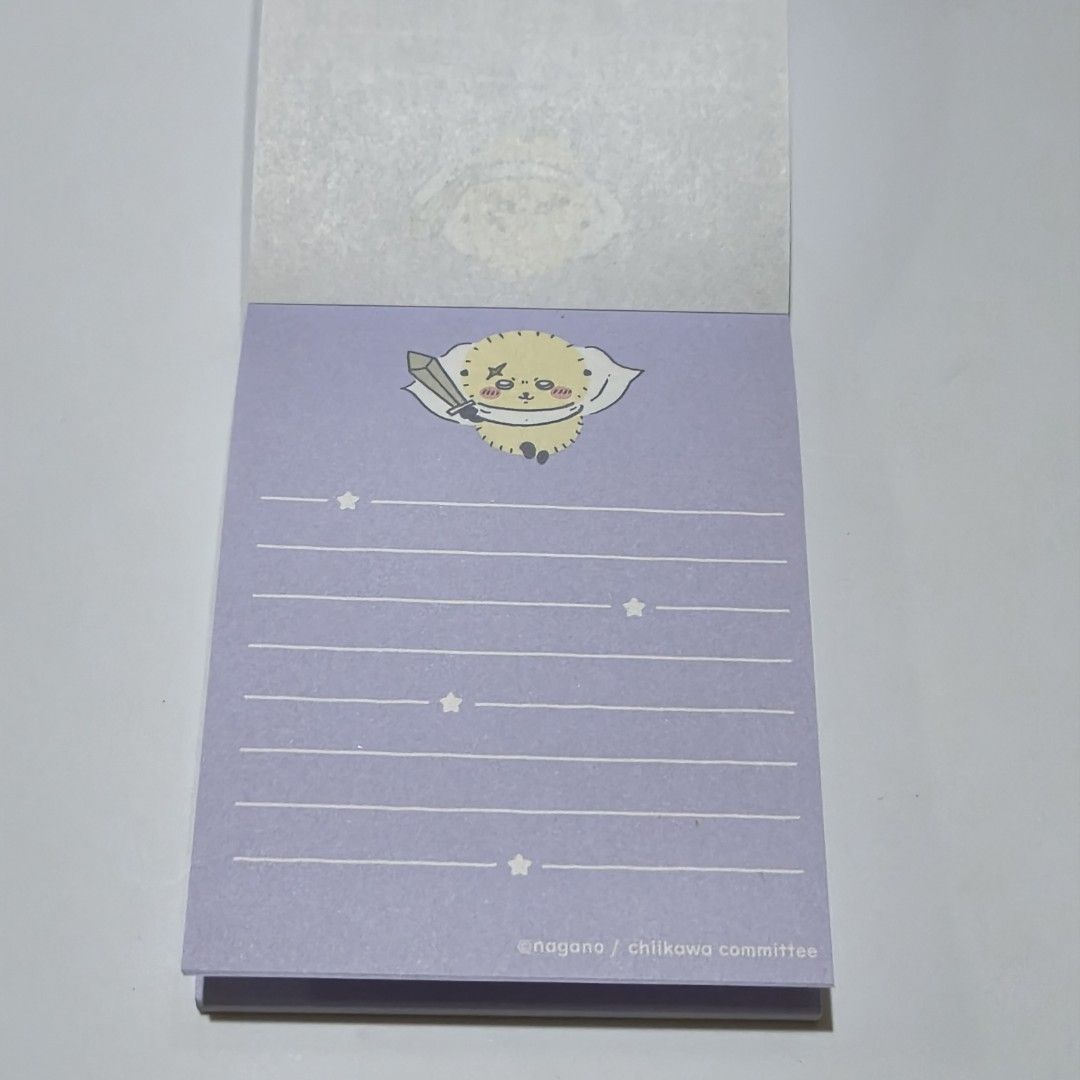 Chiikawa Notepad memo pad official merchandise Light Blue (Category: Stationery & School Supplies) located in Manila. Submitted by abbey.lee (Listing ID 1468900946, Image 3). Description: - Authentic Chiikawa & Kuriboh fantasy costume design - Official Nagano merchandise - Beautiful purple cover - Lined pages featuring cute tiny stars and character art at the top - Perfect for daily notes, journaling, or collecting.