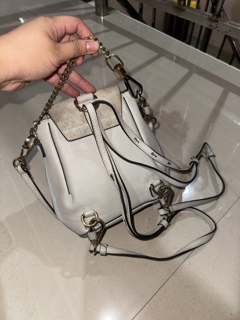 Chloé Faye Small White Leather Backpack (Category: Luxury Bags & Wallets) located in Cebu City. Submitted by latendacebu (Listing ID 1468773325, Image 3). Description: - Authentic Chloé white leather and suede convertible backpack - Features signature ring loop hardware and elegant gold-tone chain handle - Versatile design: wear as a backpack or convert into a shoulder bag - Condition: Visible discoloration and dirt marks on the suede flap, leath