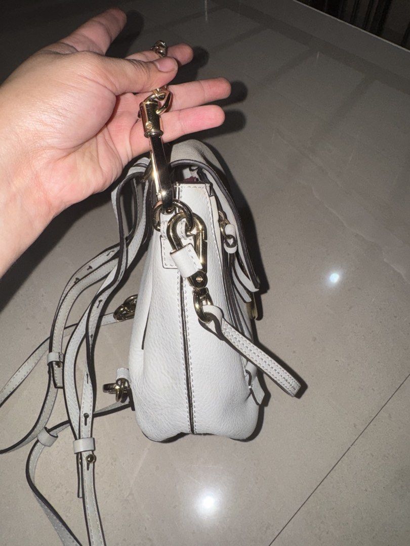 Chloé Faye Small White Leather Backpack (Category: Luxury Bags & Wallets) located in Cebu City. Submitted by latendacebu (Listing ID 1468773325, Image 2). Description: - Authentic Chloé white leather and suede convertible backpack - Features signature ring loop hardware and elegant gold-tone chain handle - Versatile design: wear as a backpack or convert into a shoulder bag - Condition: Visible discoloration and dirt marks on the suede flap, leath