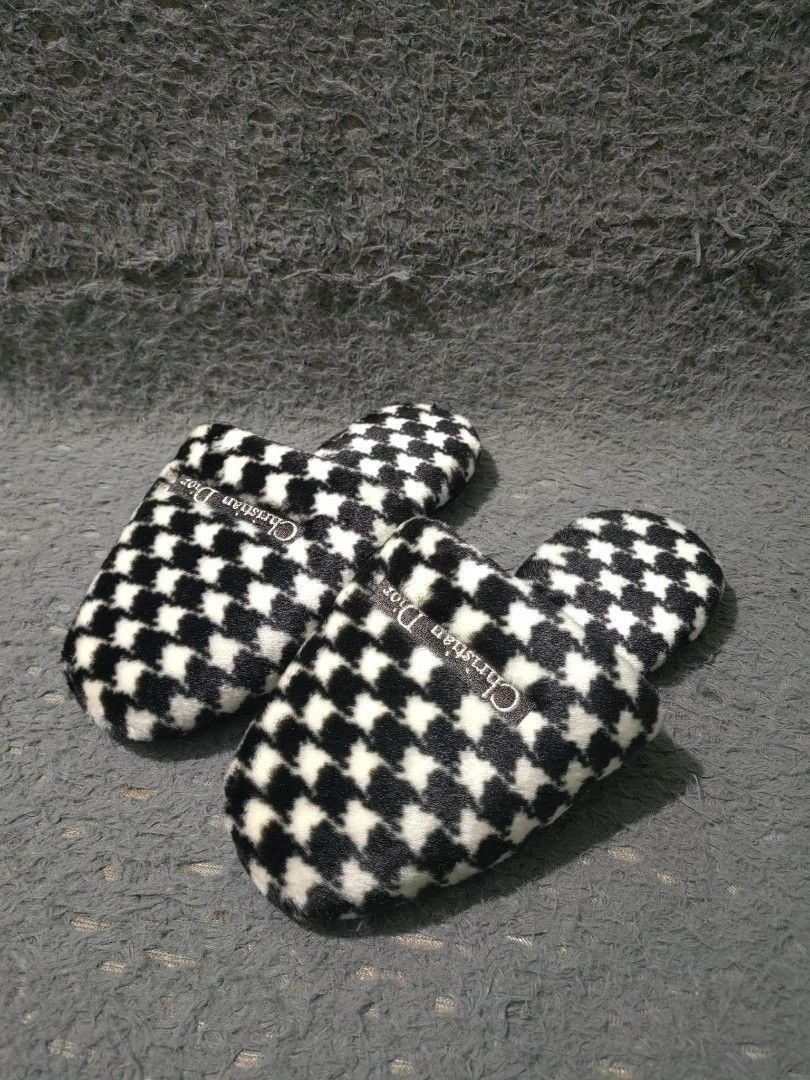 Christian Dior Houndstooth Slippers (Category: Sneakers & Footwear) located in Las Pinas. Submitted by huslerz (Listing ID 1468819018, Image 1). Description: - Brand: Christian Dior - Style: Slip-on house slippers - Design: Classic black and white houndstooth pattern with a soft fuzzy upper - Details: Small woven Dior brand tag on top - Sole: Black synthetic leather with anti-slip texture - Condition: Brand new with original stickers still attach