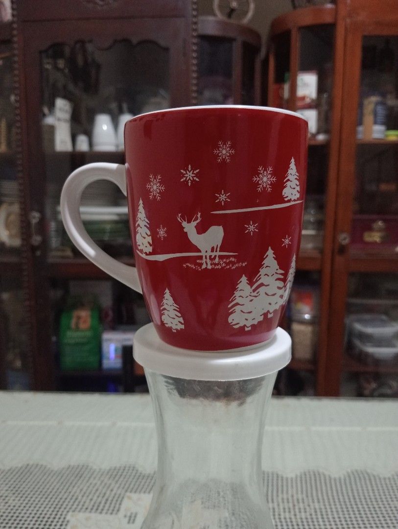 Mark's & Spencer Christmas Coffee Mug (Category: Coffee & Tea Tableware) located in Makati City. Submitted by YSL80022 (Listing ID 1468738311, Image 2). Description: - Festive red ceramic mug with white holiday graphics - Brand; Mark's & Spencer - Features cute pine trees, deer, and snowflakes all around - Clean white interior and comfortable white handle - Standard size, ideal for coffee, tea, hot cocoa, and holiday drinks - Brand new and ready 